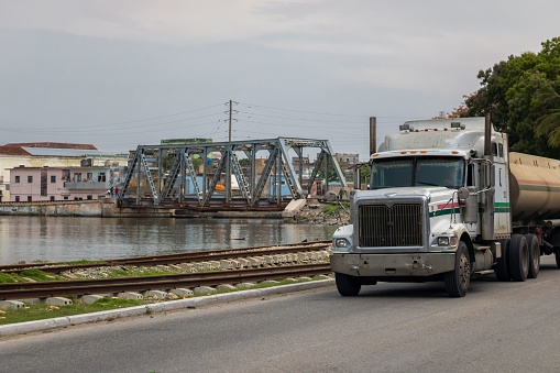 Matanzas, Cuba – June 01, 2022: a view of the truck next to train tracks and lake