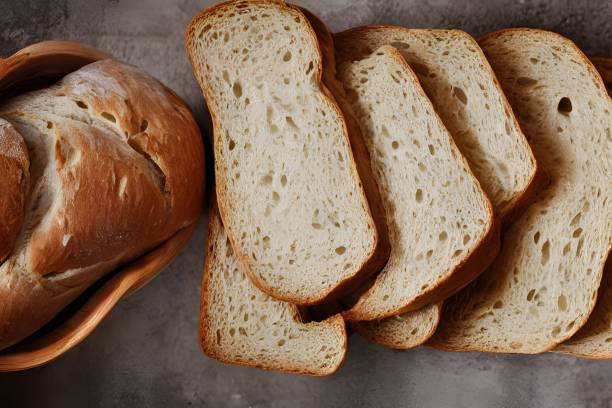istock Sliced loaf of gold rustic crusty bread on a light background 1442692465