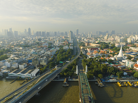 Aerial view of Phra Buddha Yodfa Bridge, Memorial Bridge and Phra Pok Klao Bridge over the Chaophraya River at sunrise scene, Bangkok City, Thailand.