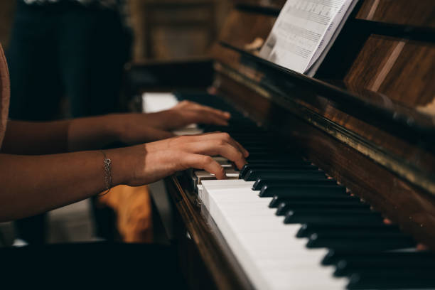 istock Female's hands playing the piano 1442693990