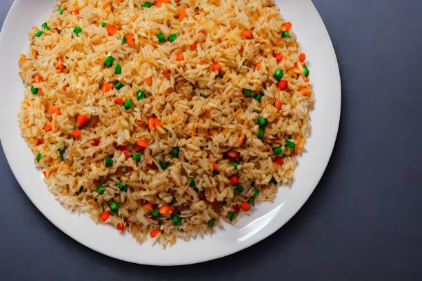 istock Top view of fried rice on a white plate against a grey background. 1442694159