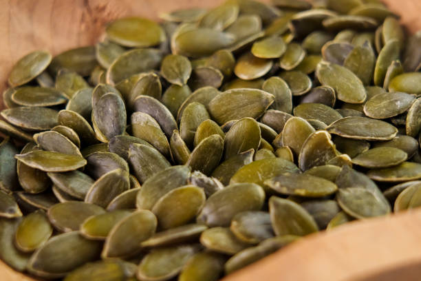 istock Pumpkin seeds. Raw fresh peeled green ingredient 1442694416