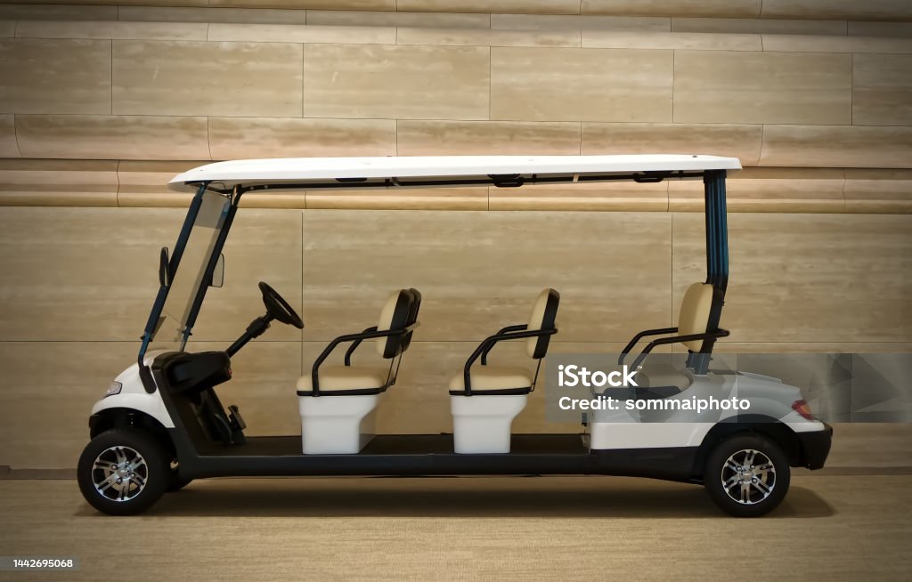 White golf cart isolated on wooden background Car Stock Photo