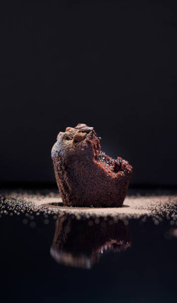 istock Closeup of chocolate muffins on a black background 1442695106