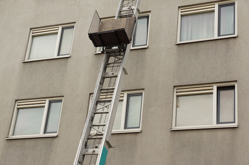 A high ladder leaning against a building