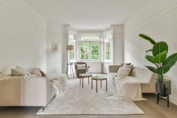 istock Spacious light living room with comfortable soft sofas; minimalist style and relaxing atmosphere 1442696063