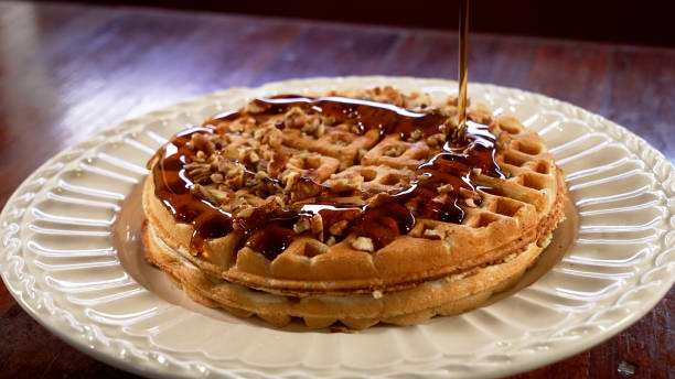 istock Closeup of waffles with honey on a white plate 1442696914