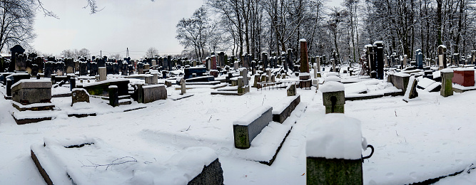 Warsaw, Poland – February 10, 2016: A panoramic view of Jewish graveyards covered by snow on a cold morning in Warsaw, Poland