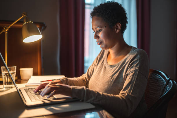 istock Multi-Ethnic Woman Using A Smart Phone And A Laptop While Working From Home 1442698139