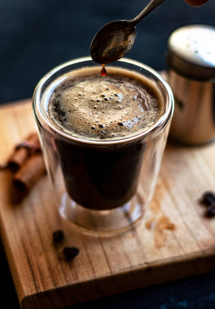 istock Double espresso coffee mug with cinnamon sticks and coffee beans on a wooden board 1442700265