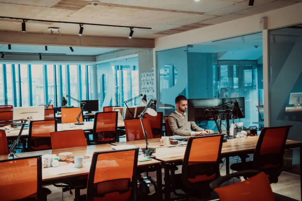 istock Modern Office: Portrait of Stylish Businessman Works on Computer, Does Data Analysis and Creative Designer, Looks at Camera and Smiles. Digital Entrepreneur Works on e-Commerce Startup Project 1442700338