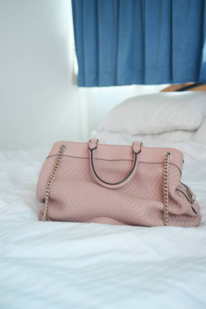 istock women purse wallet on bed, close up. 1442715477