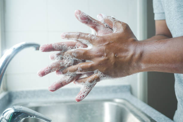 istock young man washing hands with soap warm water 1442715496