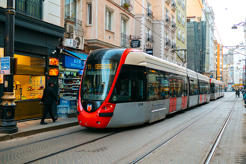 ISTANBUL, TURKEY - APRIL 1, 2022 : Modern tram passing through streets in Istanbul city