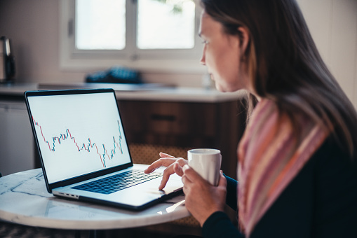 Entrepreneur Woman Checking Her Stock Market Investment Using Laptop Computer