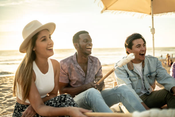 istock Friends having a picnic toasting marshmallows at the beach 1442719654