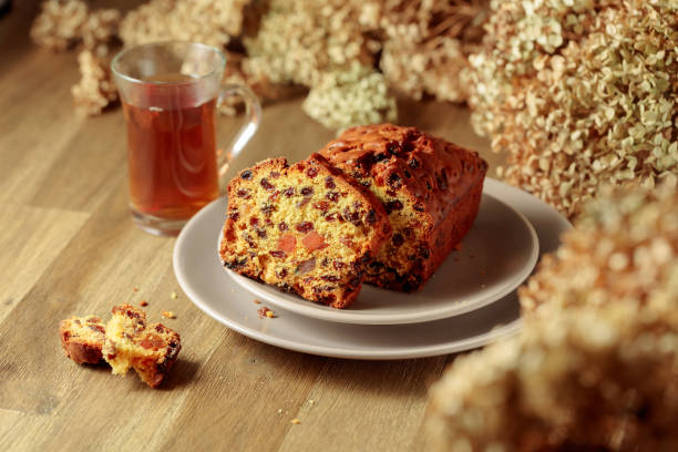 istock Fruit cake and tea on a wooden table with dried flowers. 1442719953