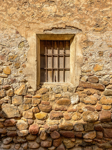 Front view of closed window in stone wall in the city of Sagunto in the Valencian Community, Spain
