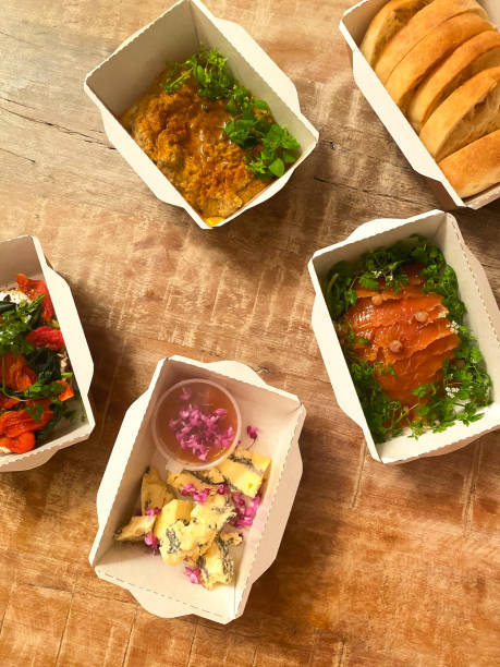 istock Assorted fresh dishes in separate disposable small paper boxes on wooden table 1442721448