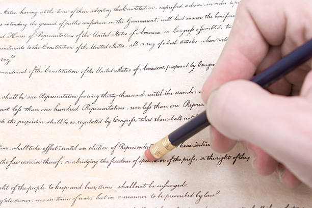 istock Closeup of Hand Pencil Erasing First Amendment to U.S. Constitution 144272257