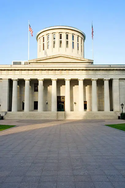 West facade of the Ohio Statehouse in Columbus, Ohio lit by sunlight.