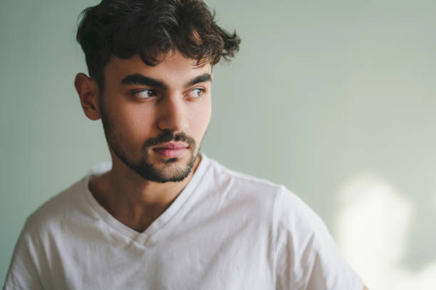 istock Young handsome man standing over green background looking away with natural expression. Isolated portrait. Green background. Positive person. Fashion model. Man portrait. 1442722904