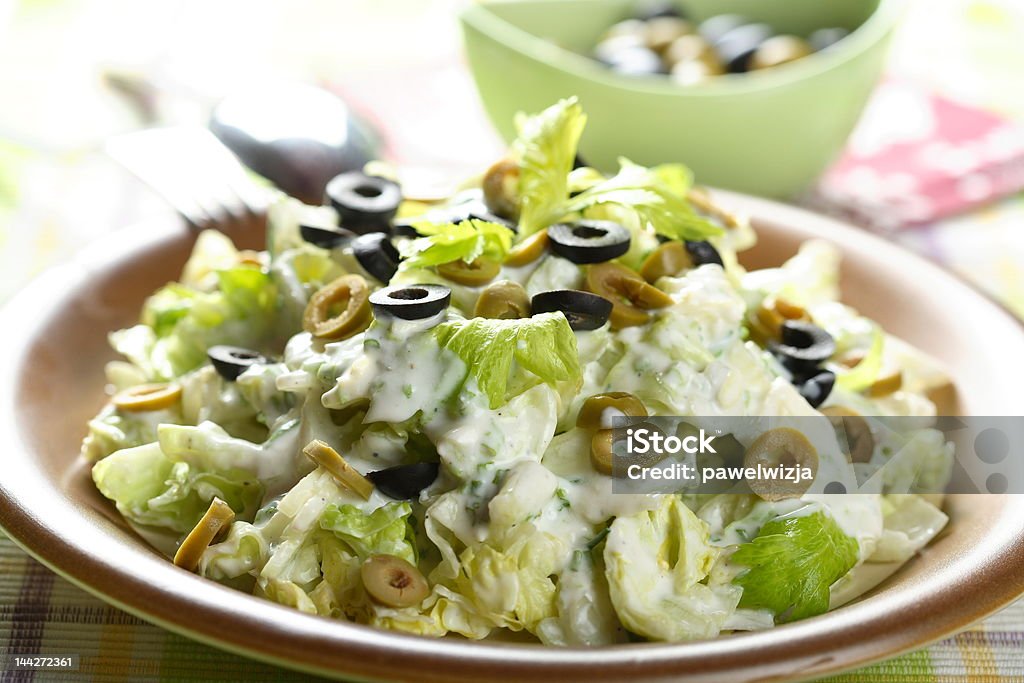 Salad with olives and celery Tasty and healthy salad with olives and celery on the plate Arranging Stock Photo