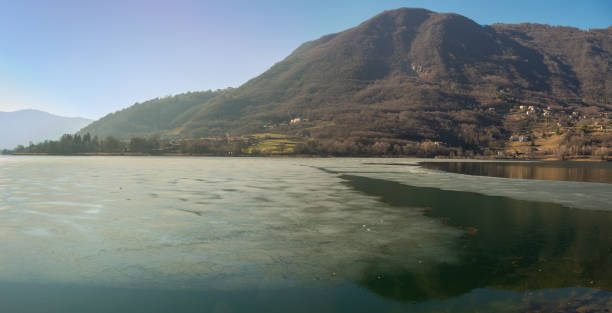 Lake Endine, Bergamo, Italy. Amazing view of the lake in winter time. Partially frozen lake. Ice covering part of the lake stock photo