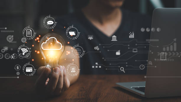 istock Business internet connection technology and digital marketing financial big data banking.Hand holding light bulb and laptop computer on desk. 1442724058