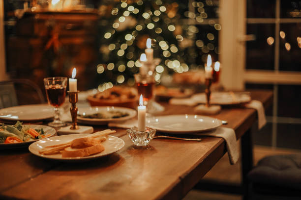 istock Christmas table is served with a duck, decorated with bright tinsel and candles 1442726712