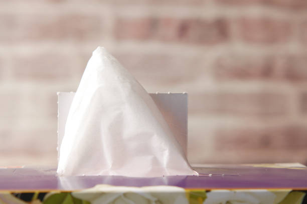 istock hand pull out a piece of tissue from tissue paper box 1442727488