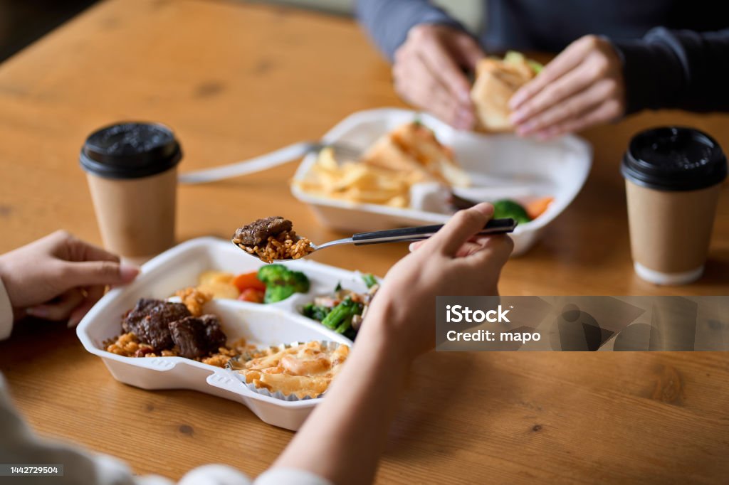 Asian woman eating lunch box Lunch Box Stock Photo