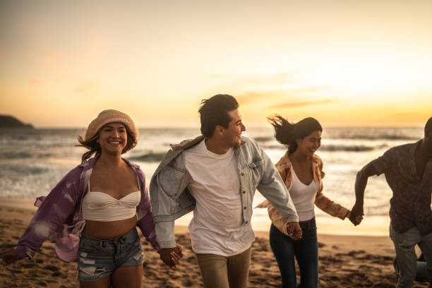 istock Friends walking holding hands at the beach 1442730934