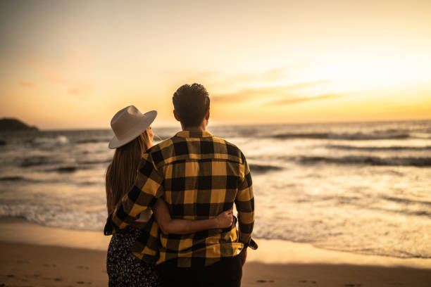 Couple enjoying sunset at the beach