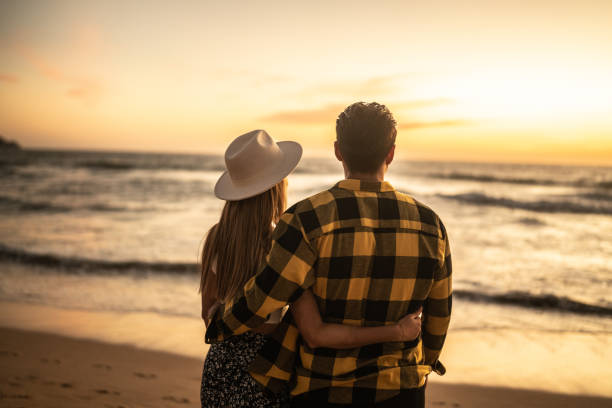istock Couple enjoying sunset at the beach 1442730958