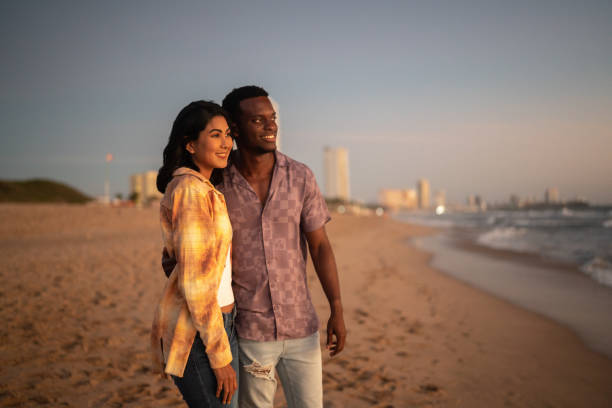 istock Couple enjoying sunset at the beach 1442731017
