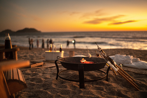 Bonfire with marshmallows at sunset on the beach