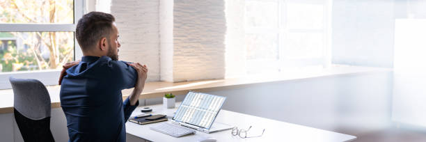 istock Employee Stretching At Office Desk 1442731829