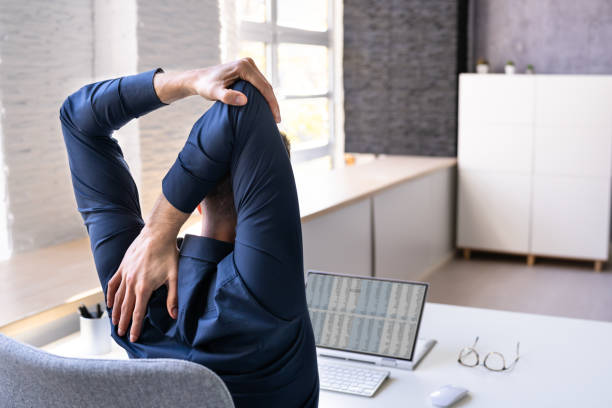 istock Employee Stretching At Office Desk 1442731849