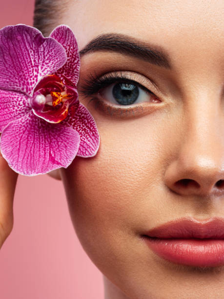 istock Beautiful woman holding flower 1442732084