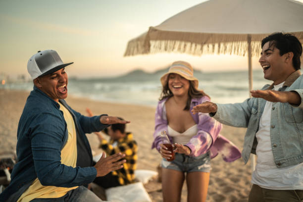 istock Young friends dancing at the beach 1442732304