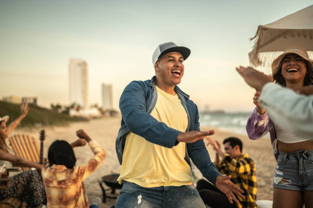 istock Young friends dancing at the beach 1442732310