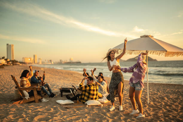 Young friends having a party at the beach