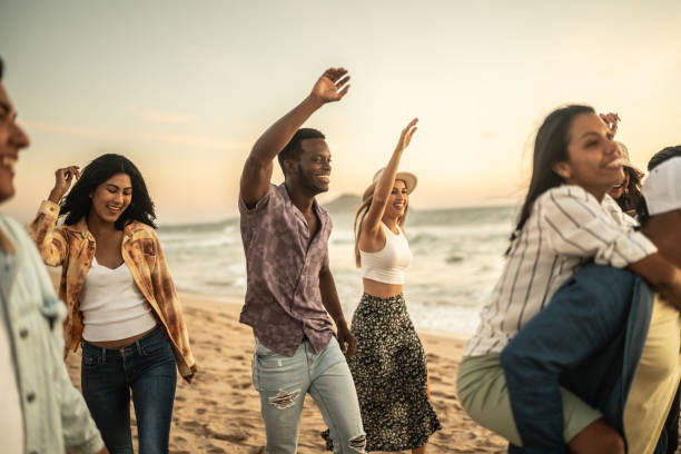 istock Friends walking on the beach 1442733618