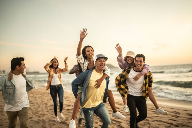 istock Friends walking and playing on the beach 1442733624