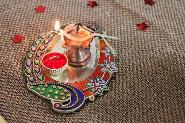 decorative pooja thali with oil lamp and kumkum for various Indian religious and traditional occassions