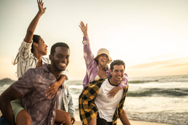 istock Friends walking and playing on the beach 1442733640