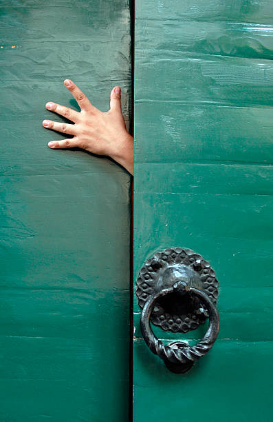 hand in doorway stock photo