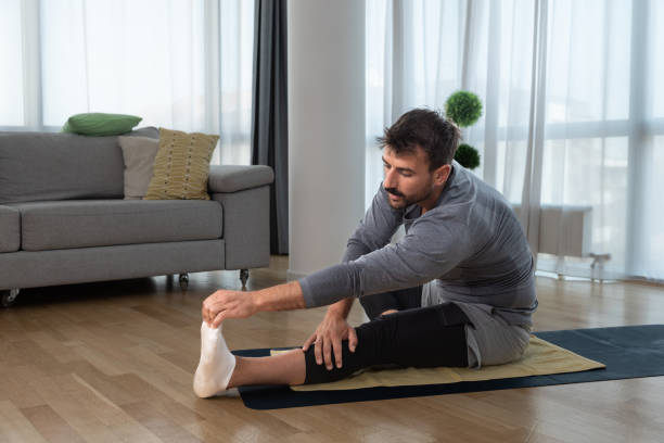 istock Young handsome fit man start to thing about himself after relationship breakup or marriage divorce and exercising at his home to improve his life. Home workout motivation and self love concept 1442735933