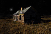 Old house with bright light in the sky above